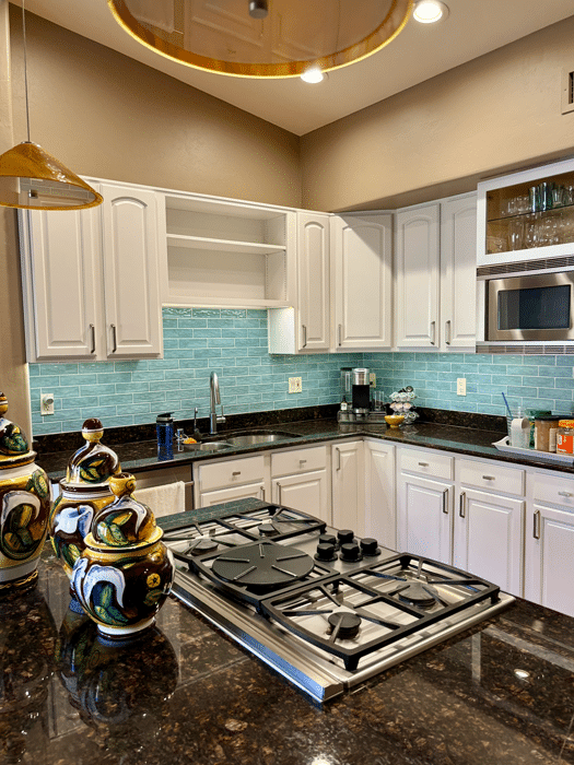 White kitchen cabinets with a smooth, professional painted finish by Red Door Painting Pros in Tucson.