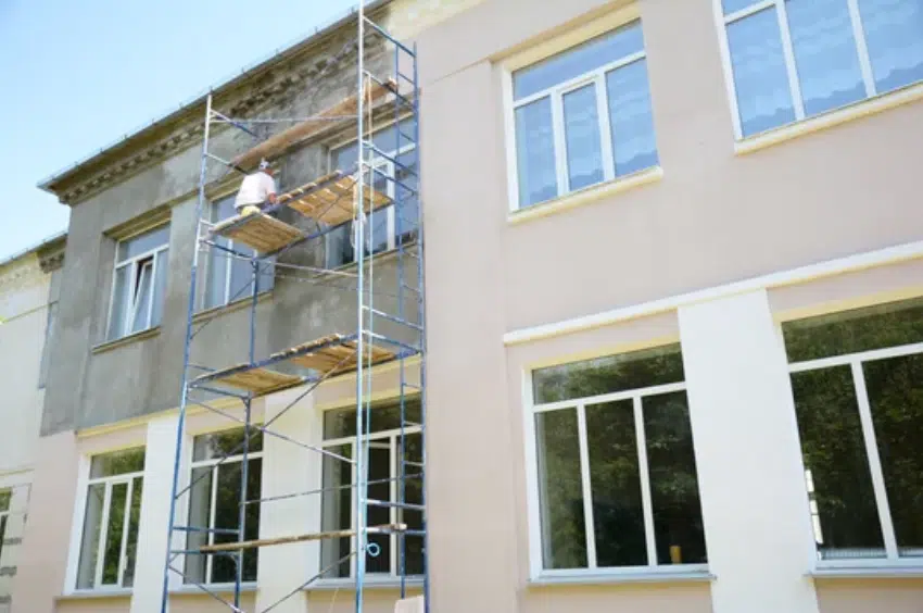 commercial-stucco-bldg Wood kitchen cabinets partially refinished to light gray, showing a before-and-after transformation by Red Door Painting Pros in Tucson.