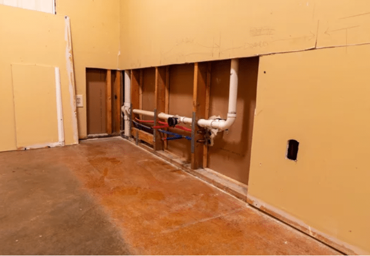 Wood kitchen cabinets partially refinished to light gray, showing a before-and-after transformation by Red Door Painting Pros in Tucson.